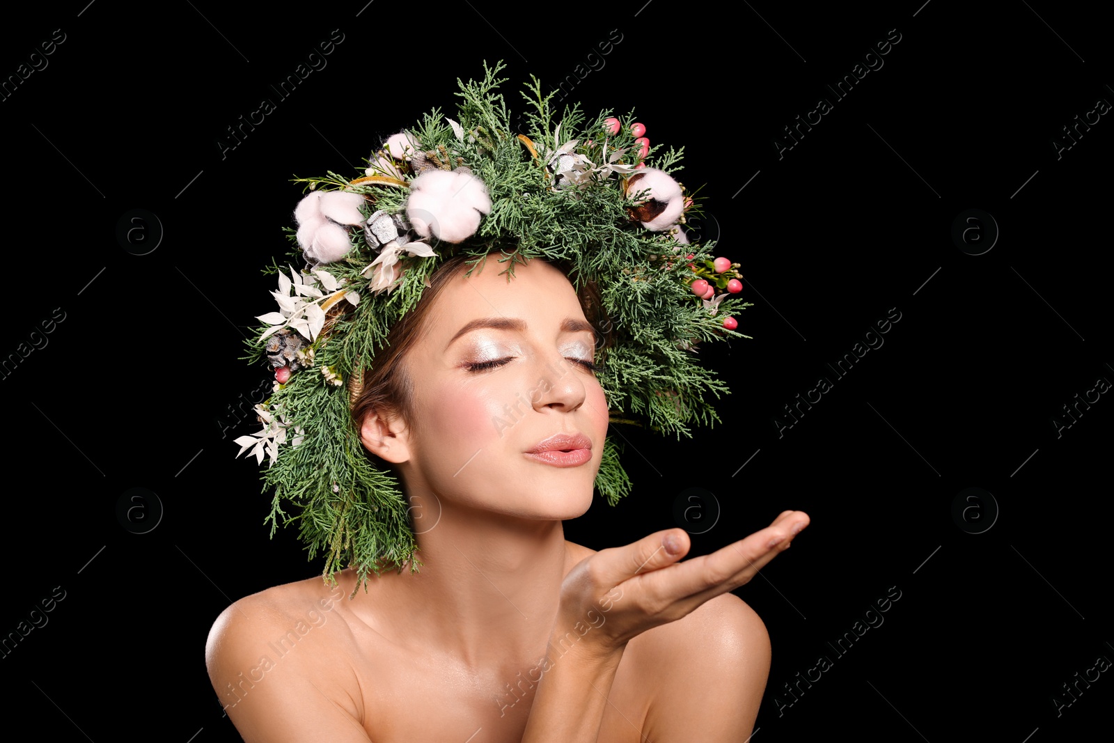 Photo of Young woman wearing wreath on black background