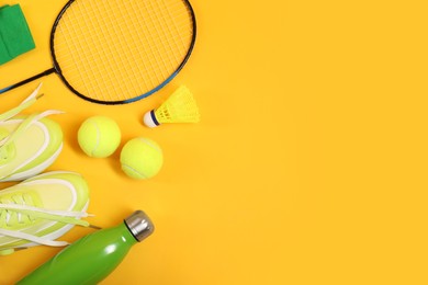 Photo of Different sports equipment on yellow background, flat lay. Space for text