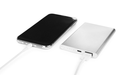 Photo of Mobile phone charging with power bank isolated on white