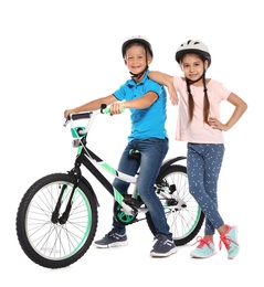 Photo of Portrait of cute little children with bicycle on white background