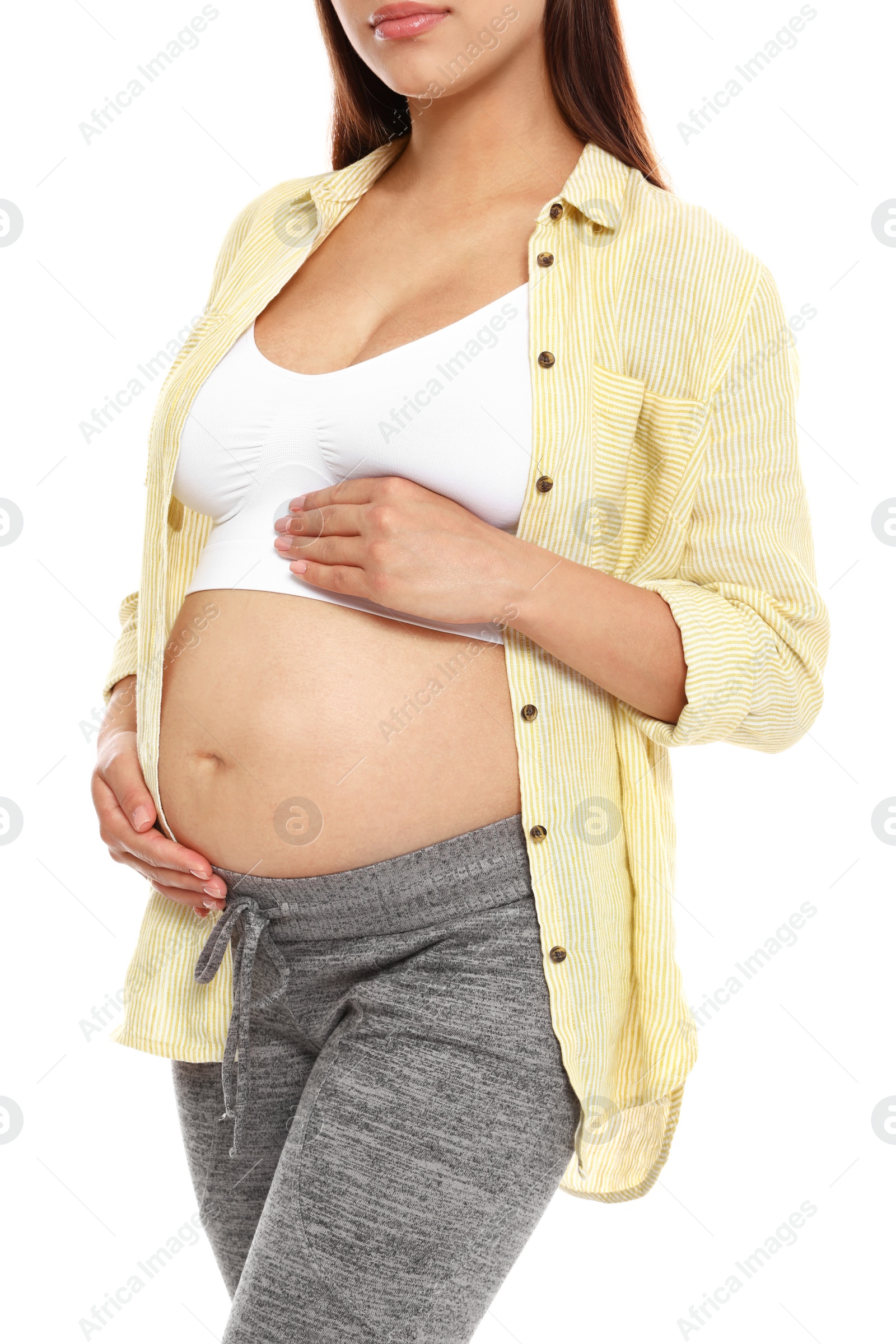 Photo of Young pregnant woman in shirt on white background, closeup