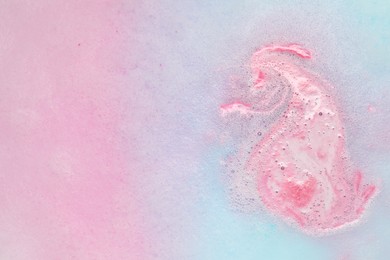 Colorful foam after dissolving bath bomb in water, closeup