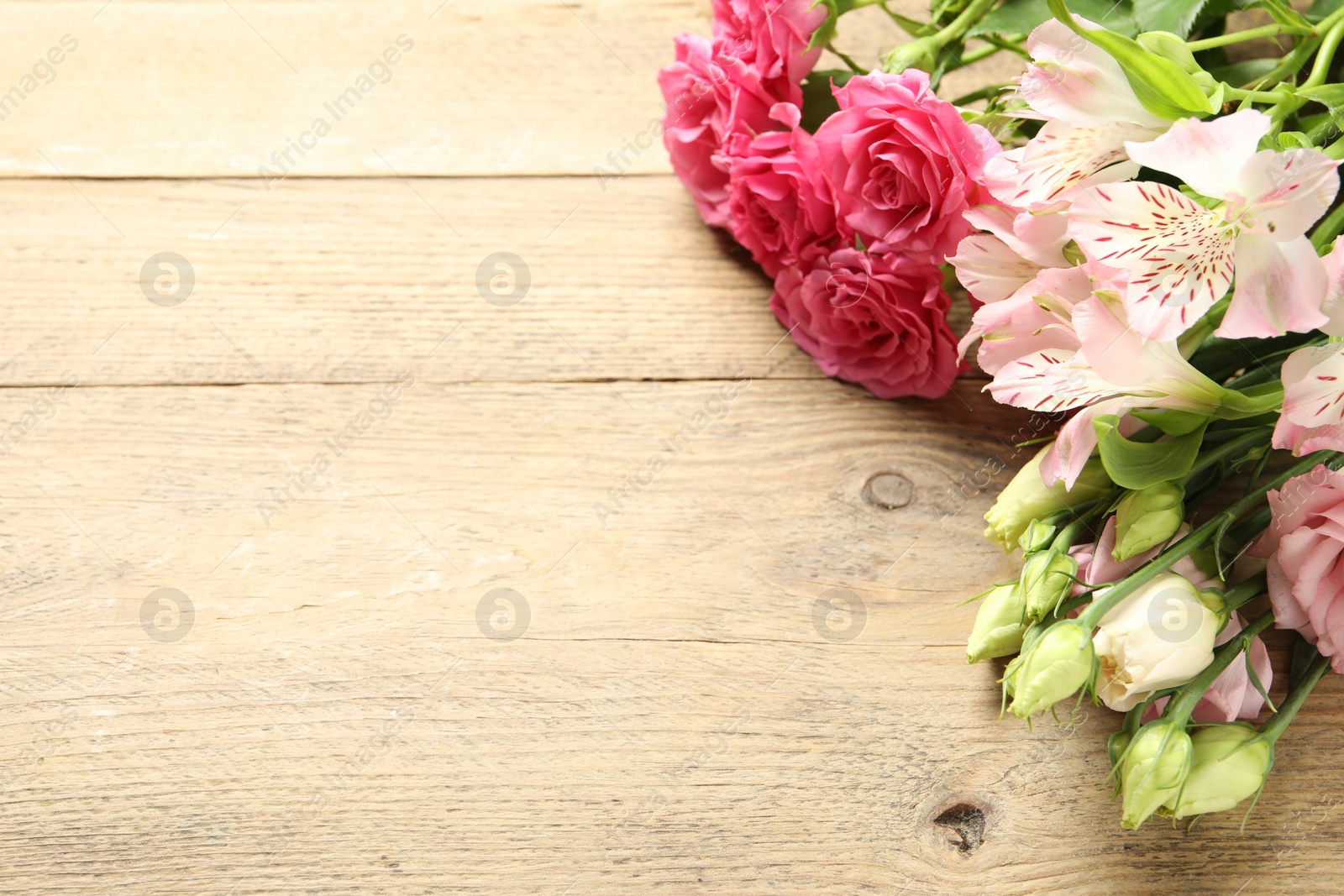 Photo of Happy Mother's Day. Beautiful flowers on wooden table, space for text