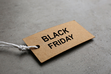 Blank tag on light grey stone background, closeup. Black Friday concept