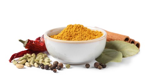 Photo of Curry powder in bowl and other spices isolated on white