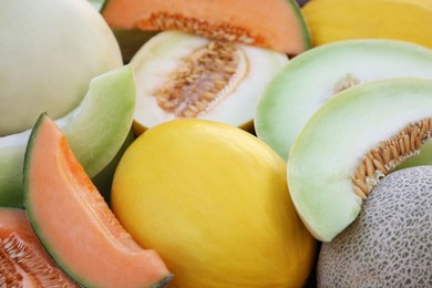 Photo of Different types of tasty ripe melons as background, closeup