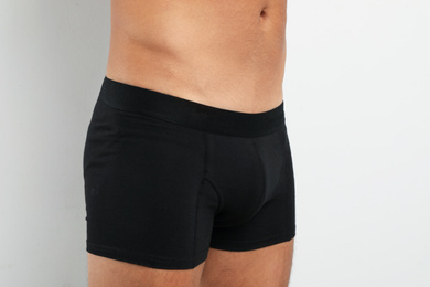 Photo of Man in black underwear on white background, closeup