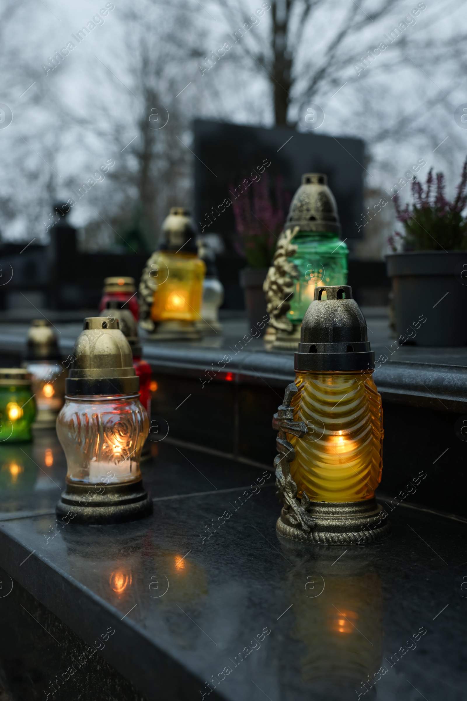 Photo of Grave lights on granite surface at cemetery