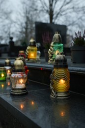 Photo of Grave lights on granite surface at cemetery