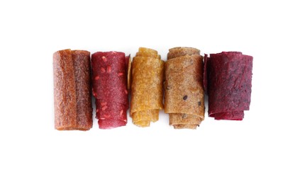 Delicious fruit leather rolls on white background, top view