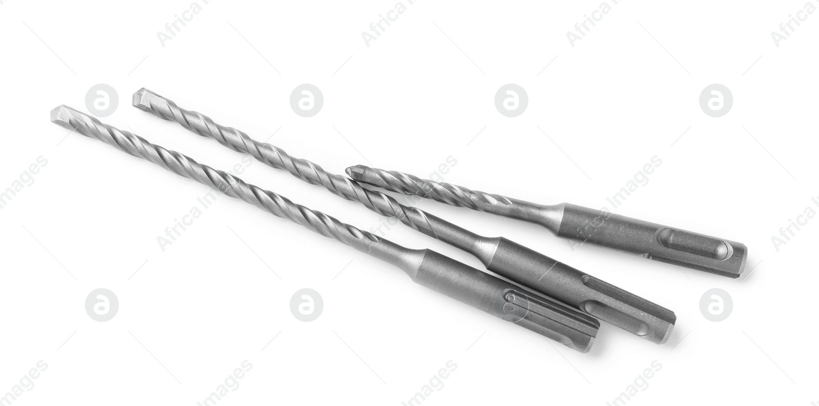 Photo of Many twist drill bits isolated on white, top view. Carpenter's tools