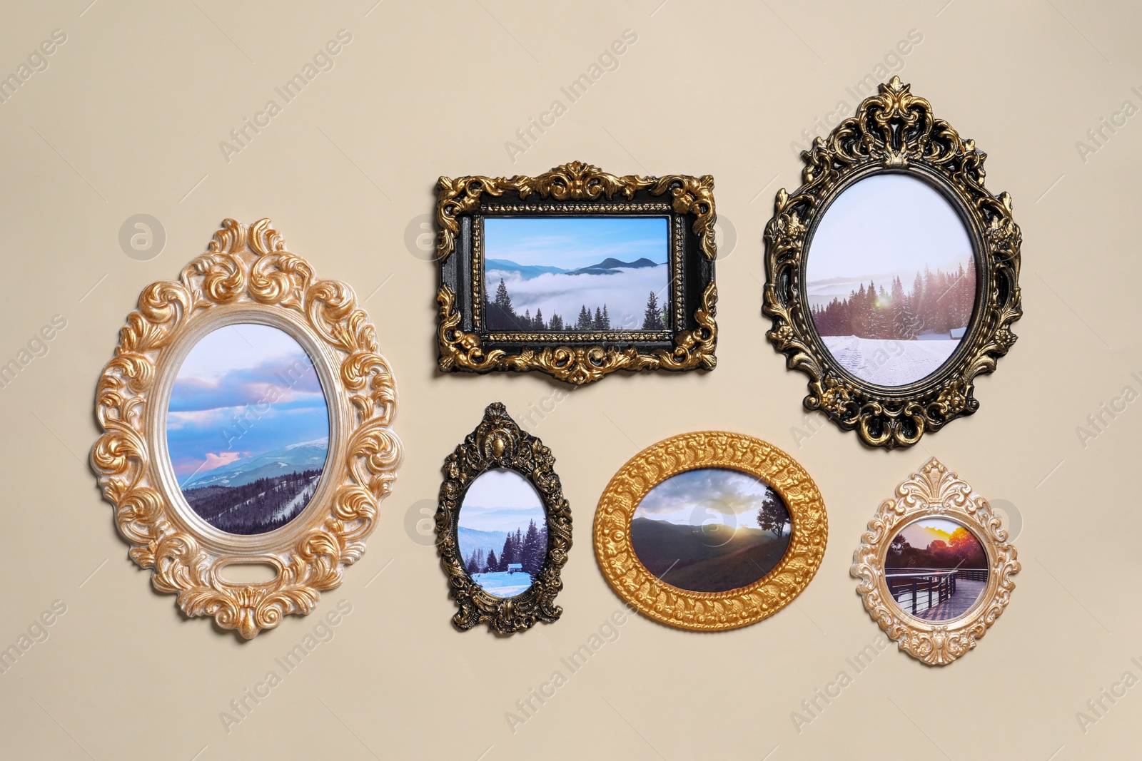 Photo of Vintage frames with photos of beautiful landscapes hanging on beige wall