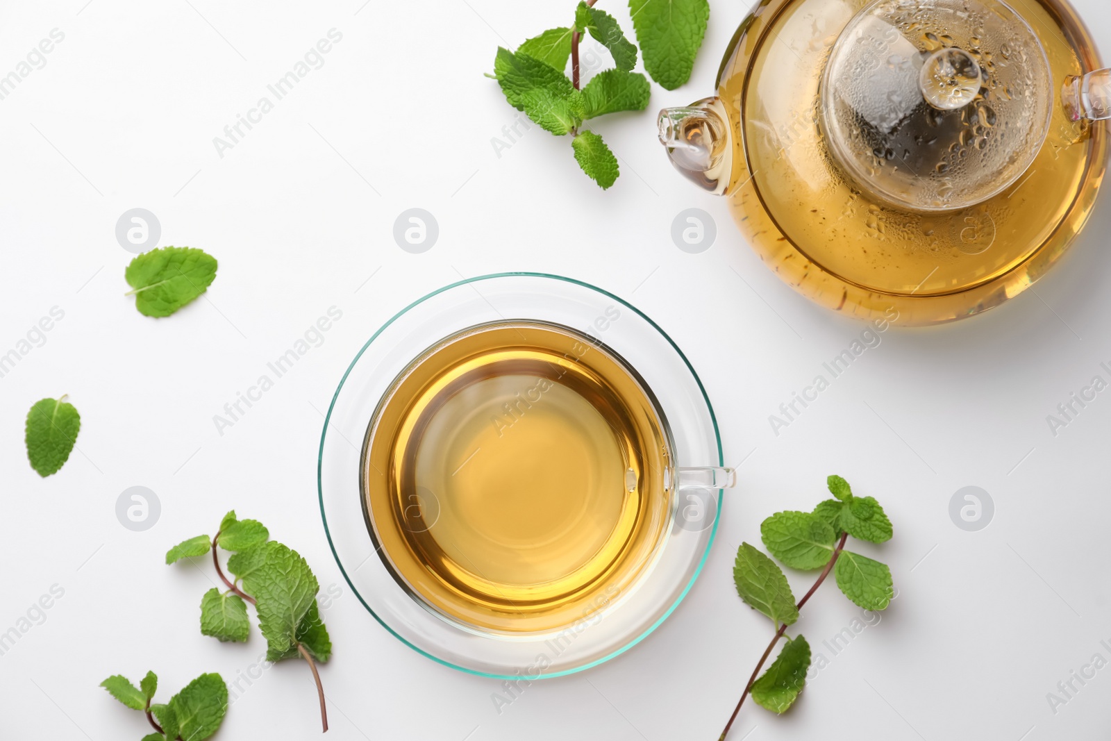 Photo of Aromatic herbal tea with mint on white table, flat lay