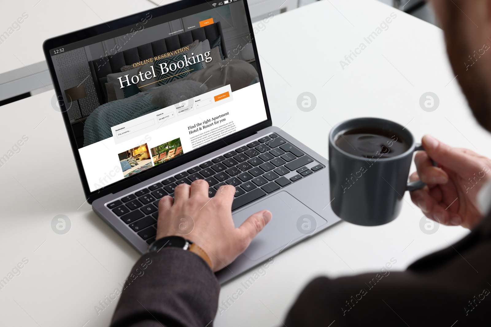 Image of Man using laptop to book hotel at white table, closeup