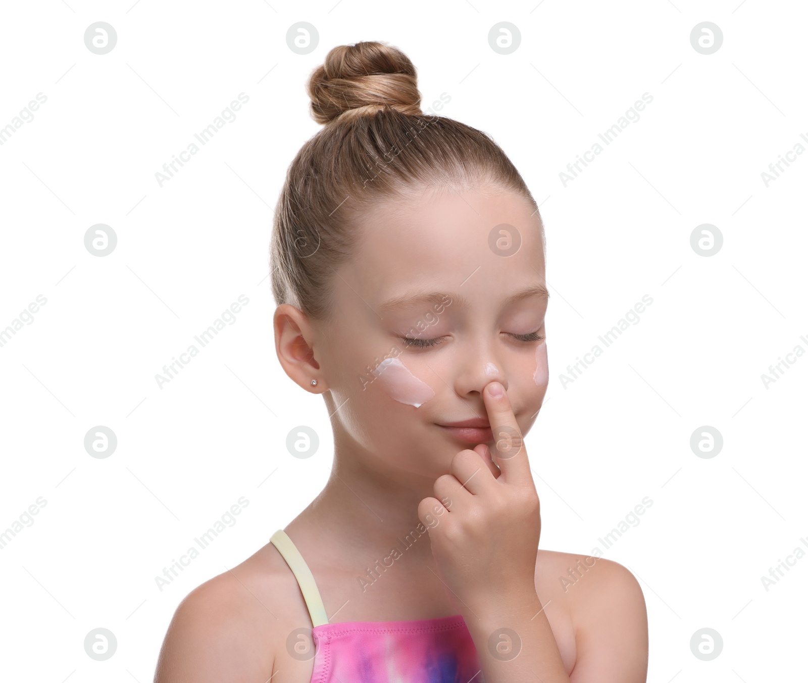 Photo of Happy girl applying sun protection cream onto her face isolated on white