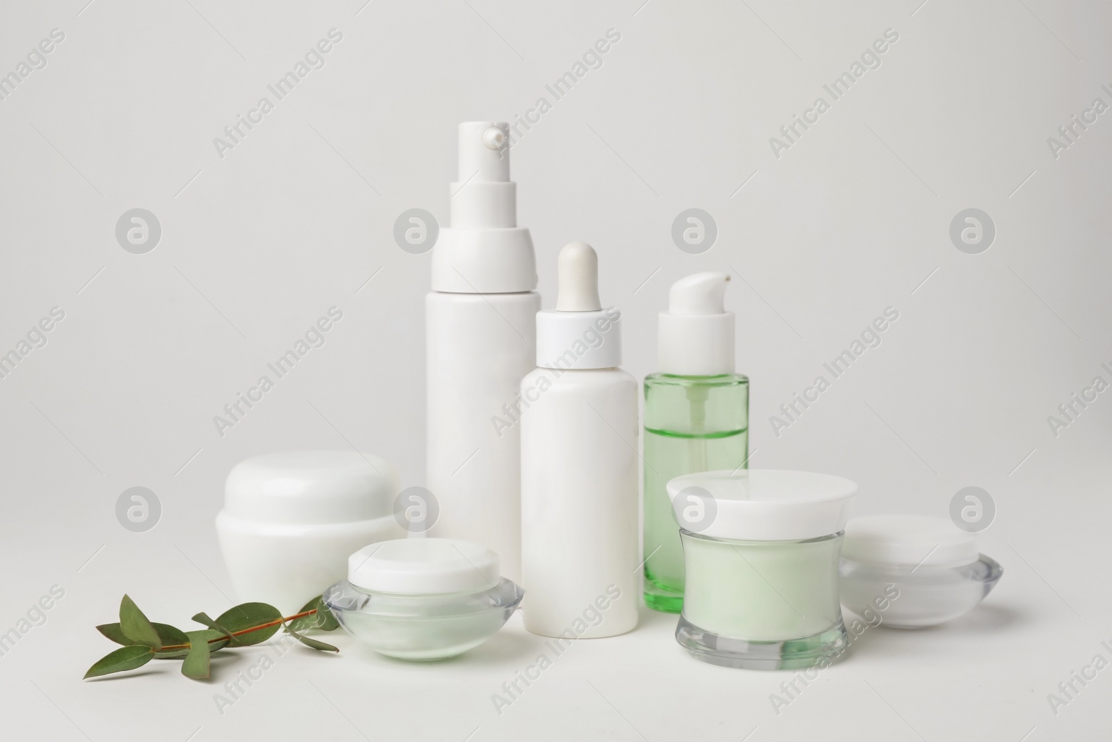 Photo of Composition with cosmetic products on light background