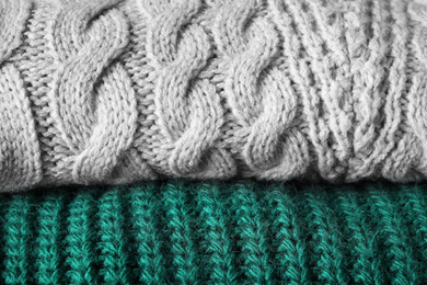 Folded warm sweaters as background, closeup view