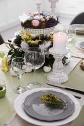 Photo of Beautiful Easter table setting with floral decor indoors