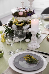 Beautiful Easter table setting with floral decor indoors