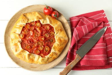 Tasty tomato galette (Caprese galette) on white wooden table, top view