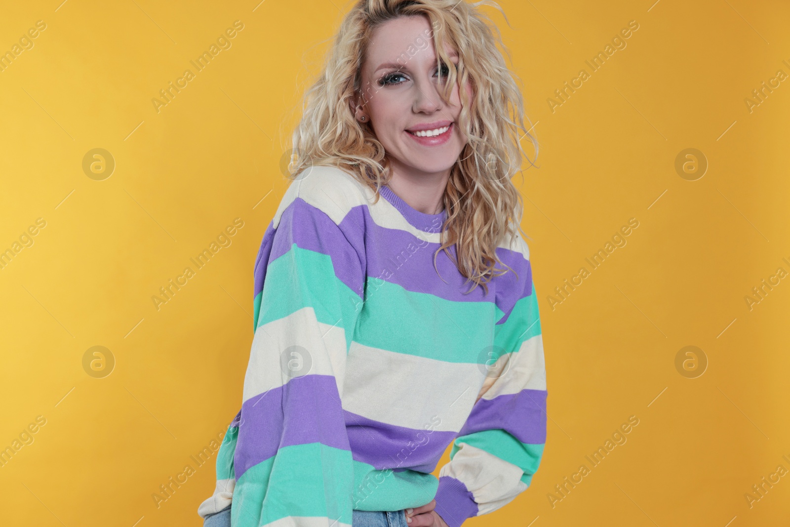 Photo of Portrait of beautiful young woman on orange background