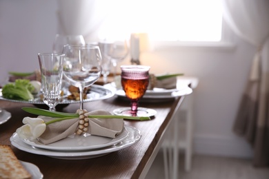 Festive Passover table setting at home, space for text. Pesach celebration