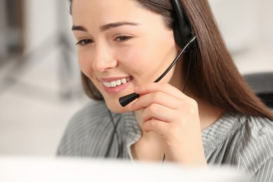 Photo of Hotline operator with headset working in office, closeup