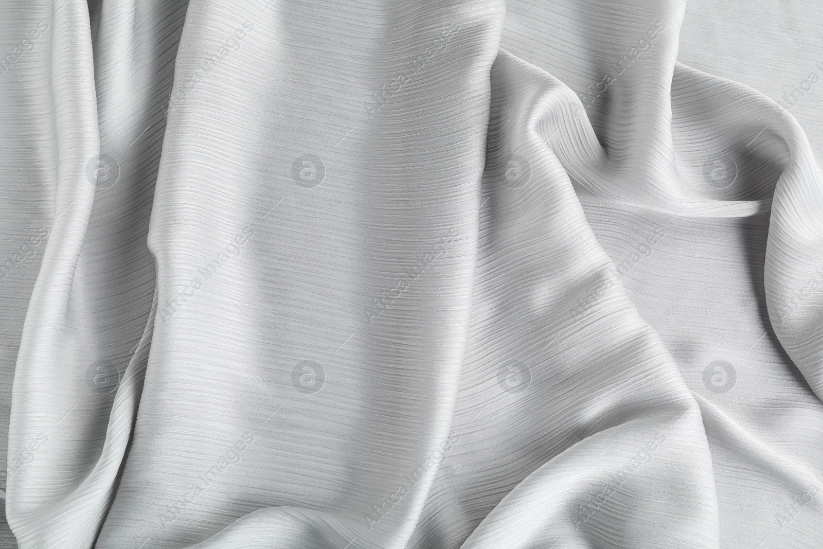 Photo of Beautiful grey tulle fabric as background, top view