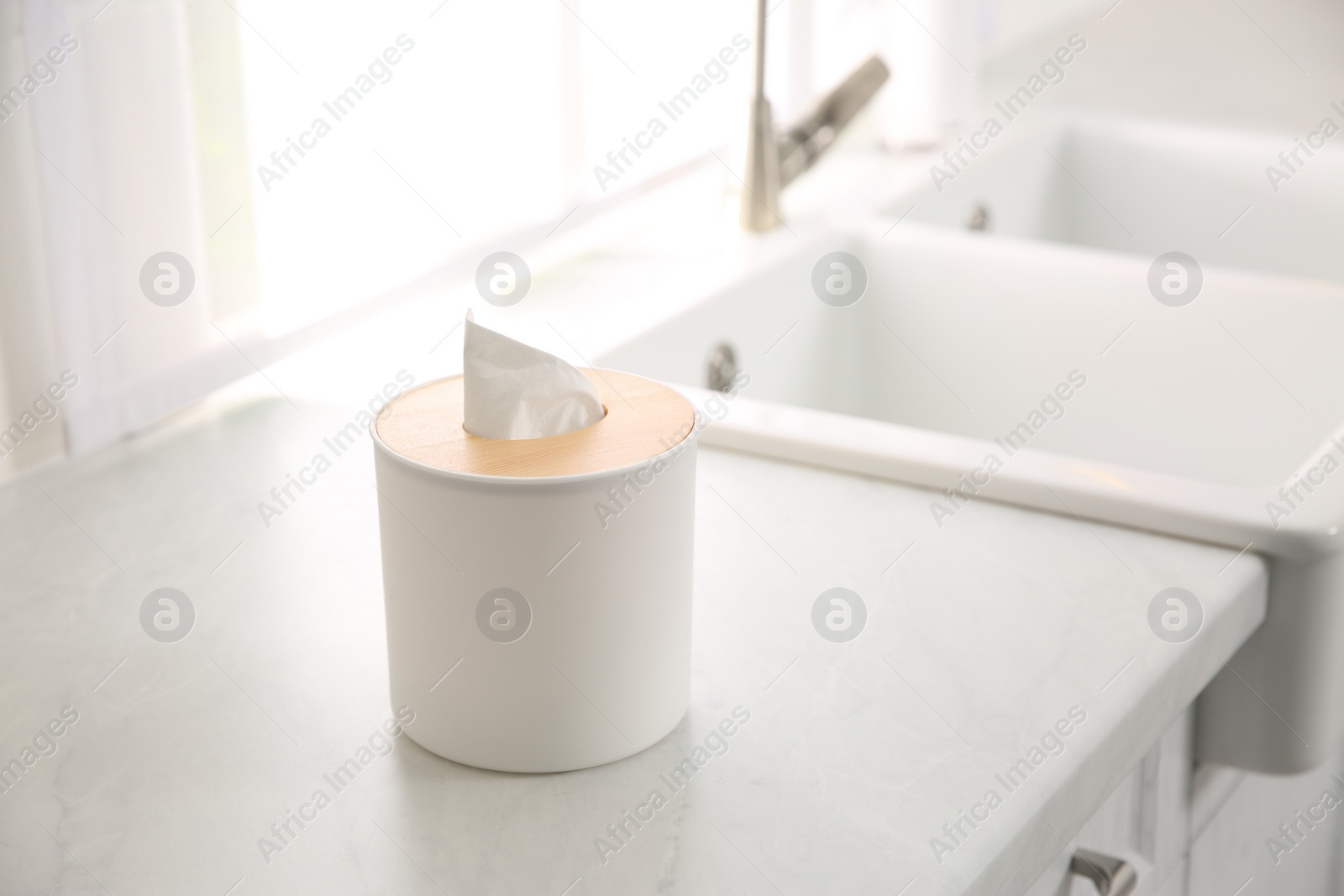 Photo of Box with paper tissues on white countertop in kitchen