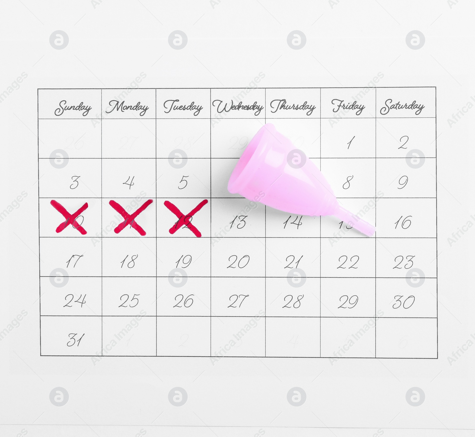 Photo of Calendar and menstrual cup on white background, top view. Gynecological care