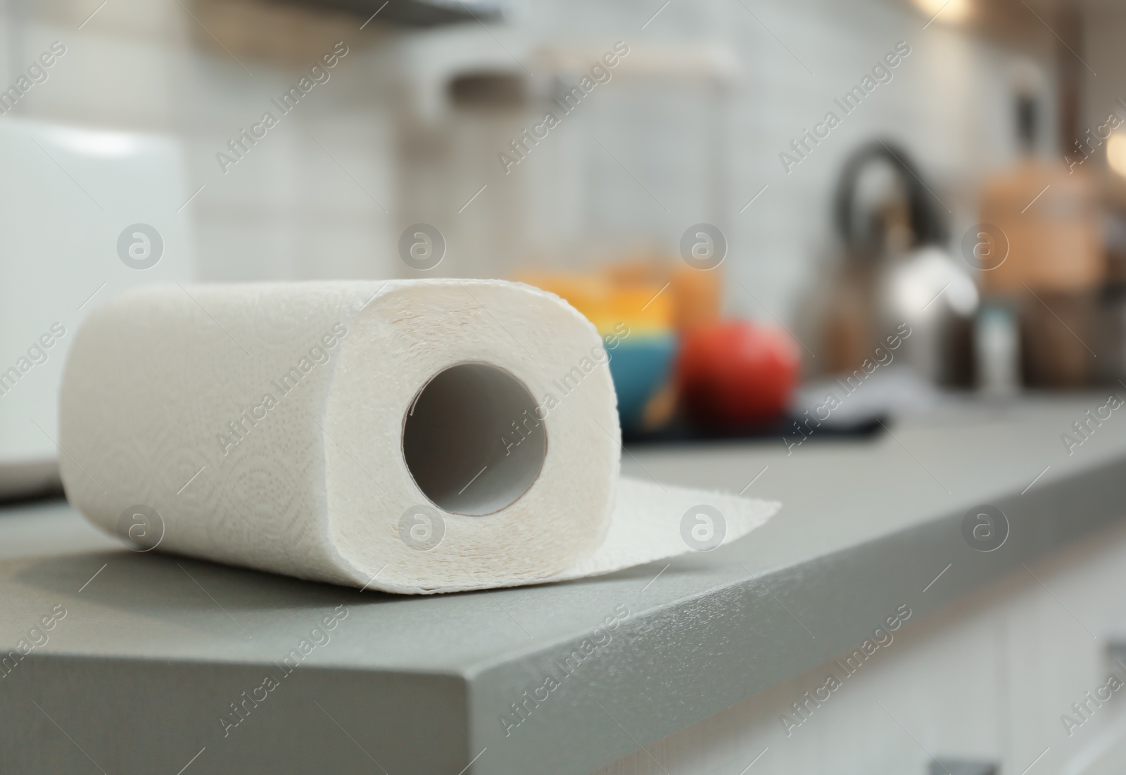 Photo of Roll of paper towels on table in kitchen, space for text