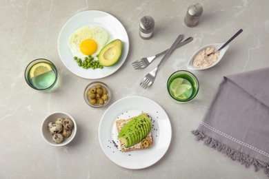 Photo of Tasty breakfast with crisp avocado  toast on table, top view