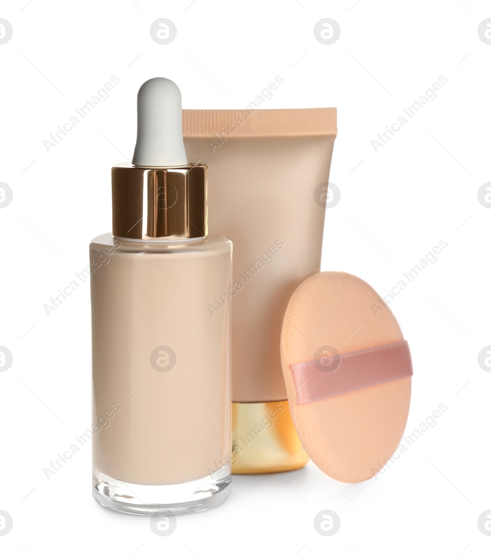 Photo of Sponge, bottle and tube with skin foundation on white background. Makeup products