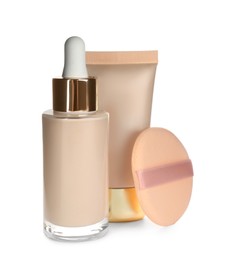 Photo of Sponge, bottle and tube with skin foundation on white background. Makeup products