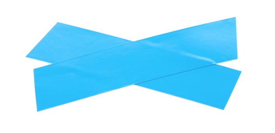 Crossed pieces of light blue insulating tape on white background, top view