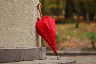 Autumn atmosphere. One red umbrella in park