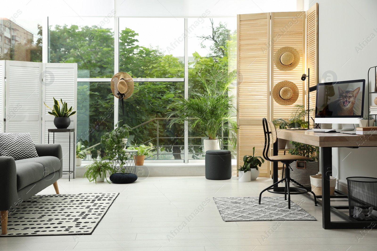 Photo of Comfortable workplace with computer in light room. Interior design