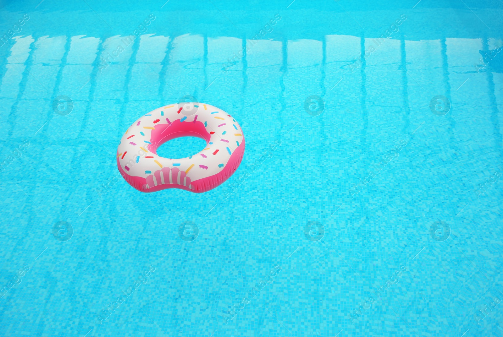 Photo of Inflatable ring floating on water in swimming pool