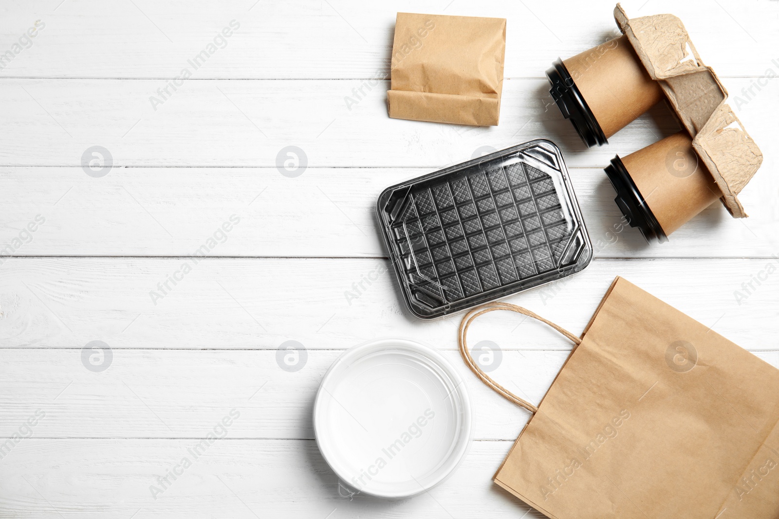 Photo of Different containers for mock up design on wooden background, flat lay. Food delivery service