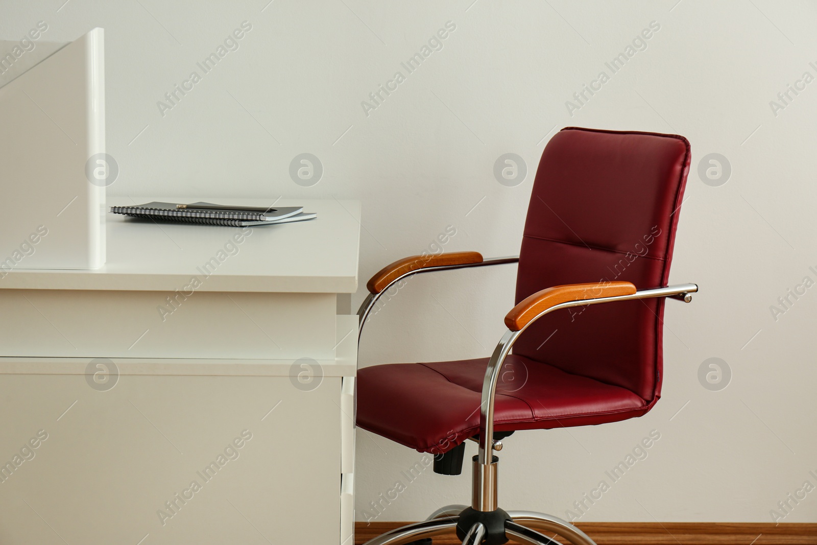 Photo of Stylish workplace interior with modern office chair and desk