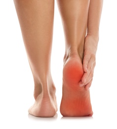 Woman suffering from foot pain on white background, closeup