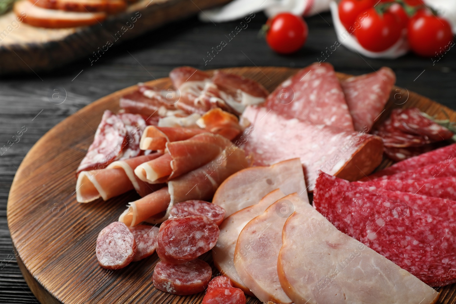 Photo of Cutting board with different sliced meat products served on table