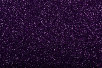 Photo of Shiny dark purple glitter as background, closeup