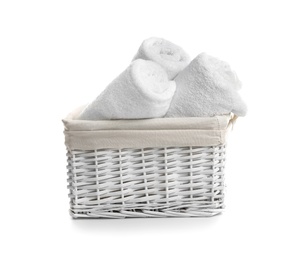 Photo of Rolled soft towels in basket on white background