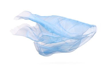 Photo of Beautiful light blue tulle fabric flying on white background