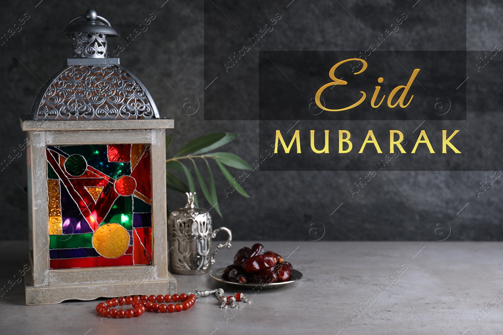 Image of Eid Mubarak greeting card. Composition with Arabic lantern and misbaha on grey table