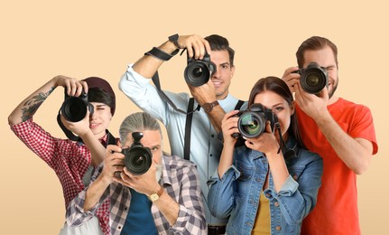 Image of Group of professional photographers with cameras on beige background