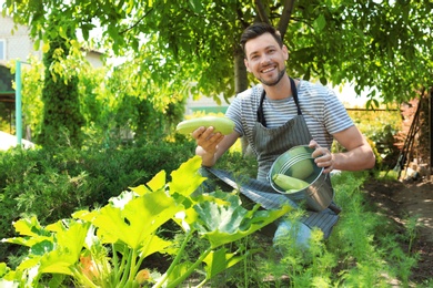 Photo of Man working in garden on sunny day