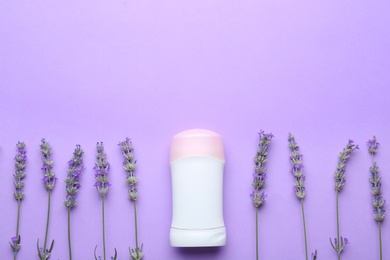 Photo of Female deodorant and lavender flowers on lilac background, flat lay