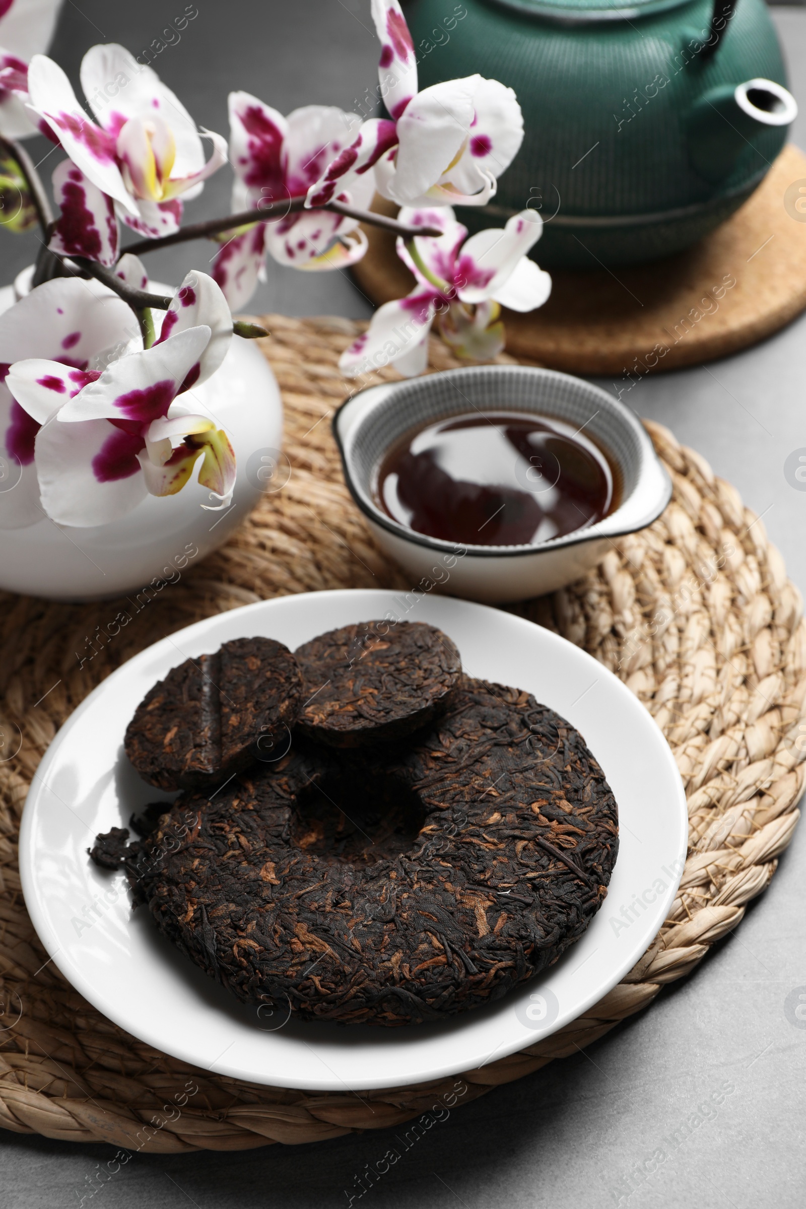 Photo of Composition with aromatic pu-erh tea on grey table